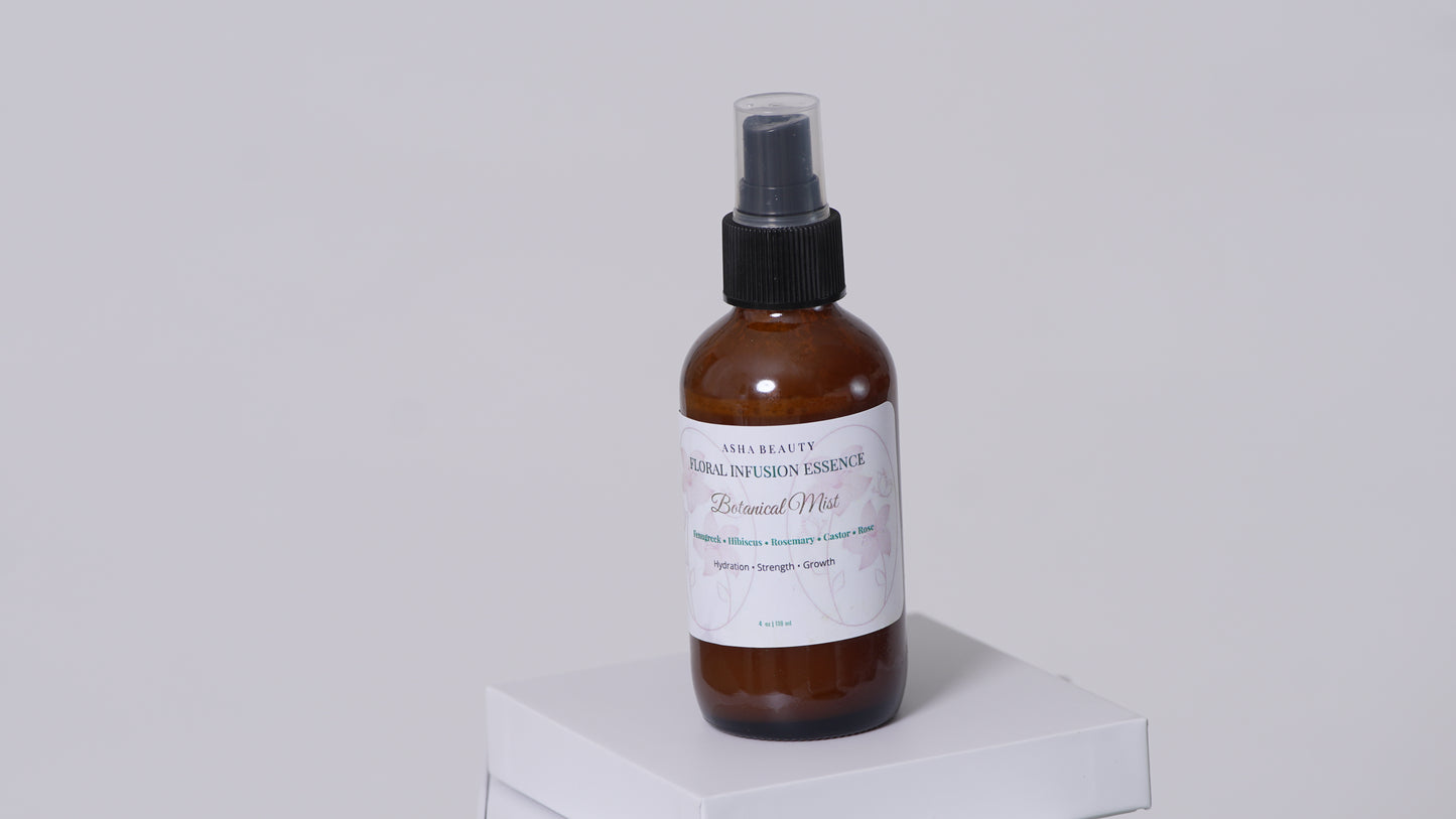Asha Belle Beauty Floral Infusion Botanical Mist amber bottle on white pedestal, natural curl care hair spray 4 fl oz