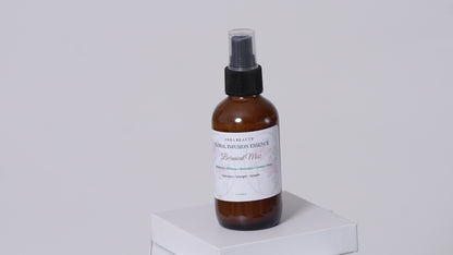 Asha Belle Beauty Floral Infusion Botanical Mist amber bottle on white pedestal, natural curl care hair spray 4 fl oz