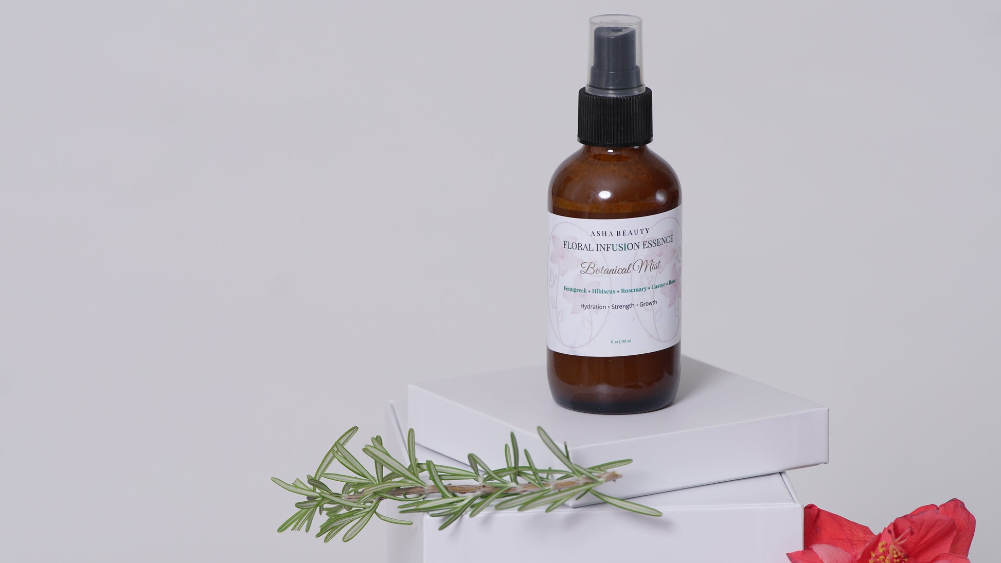 Floral Infusion Botanical Mist by Asha Belle Beauty styled with rosemary and hibiscus flower