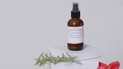 Floral Infusion Botanical Mist by Asha Belle Beauty styled with rosemary and hibiscus flower