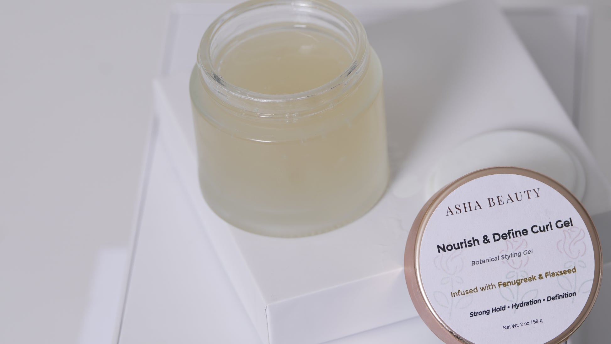 Asha Belle Beauty Nourish & Define Curl Gel open jar showing gel texture, fenugreek and flaxseed formula